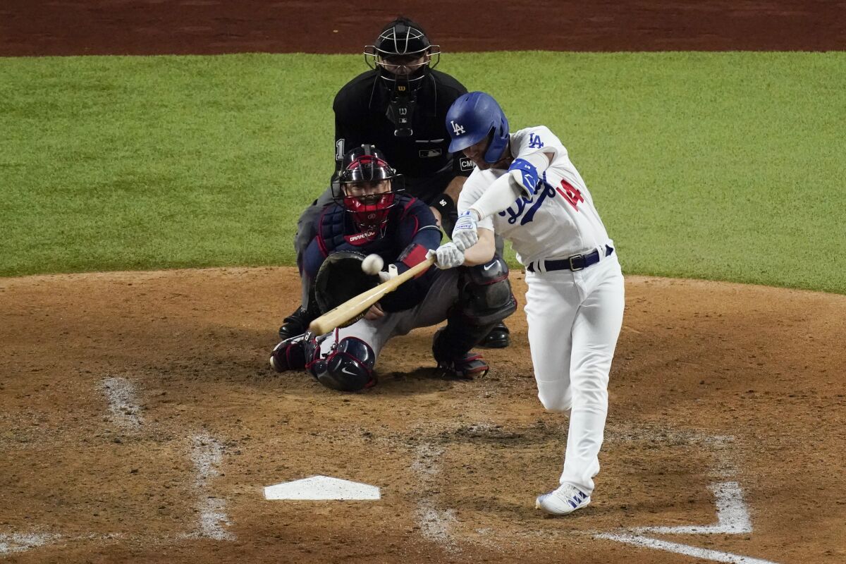 Dodgers second baseman Kiké Hernández hits a home run against the Atlanta Braves during the fifth inning of Game 1.