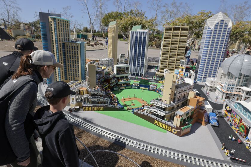 CARLSBAD, CA - MARCH 25, 2023: Carlsbad residents Kaitlin and Greg Tate, with son Landon, 8, look at a LEGO version of Petco Park, which is part of Miniland San Diego at Legoland in Carlsbad on Saturday, March 25, 2023. (Hayne Palmour IV / For The San Diego Union-Tribune)