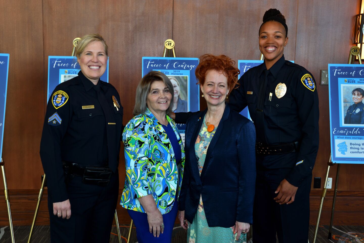 San Diego Police Department honorees Senior Detective Lori Adams, records administrator Silvia Satrom (from left) and Officer Kalena Tutt (right) stand with San Diego Police Foundation President and Chief Executive Sara Napoli at the "Women in Blue: Heart & Valor" luncheon.
