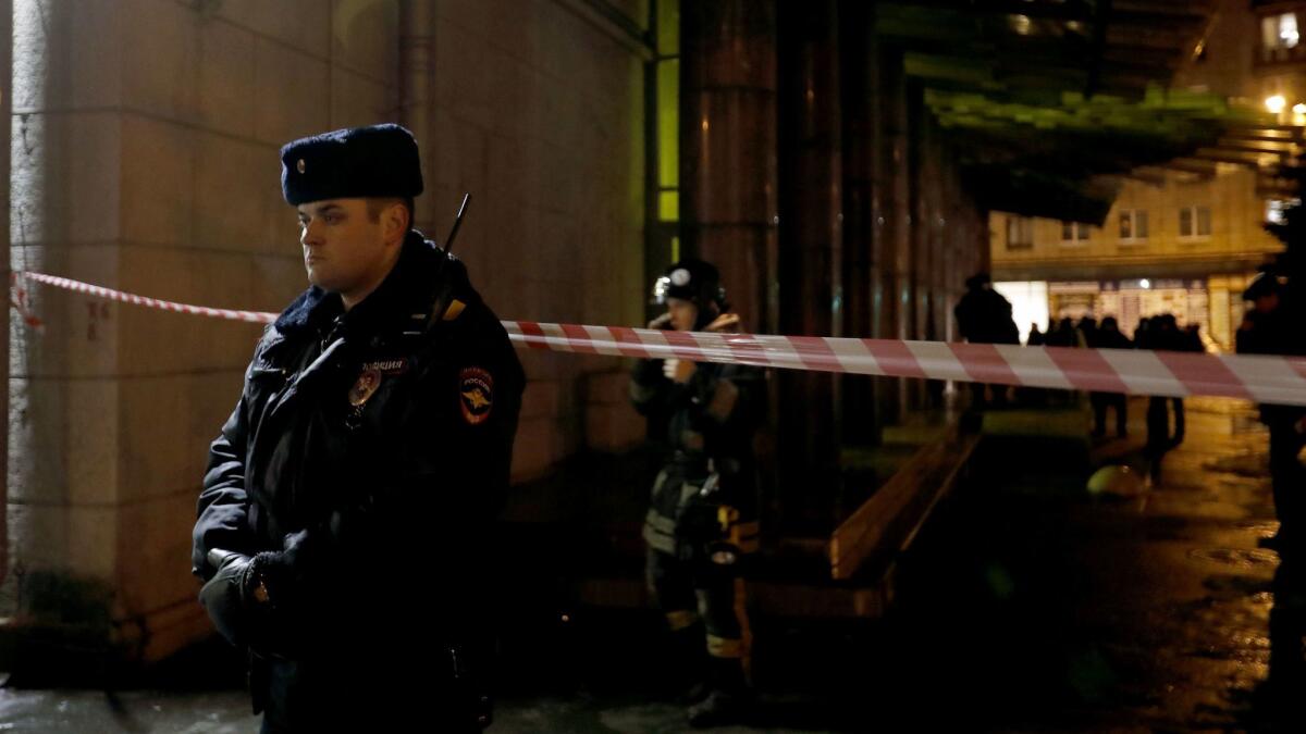 Police officers and firefighters work at the site of an explosion Dec. 27 in a St. Petersburg supermarket.