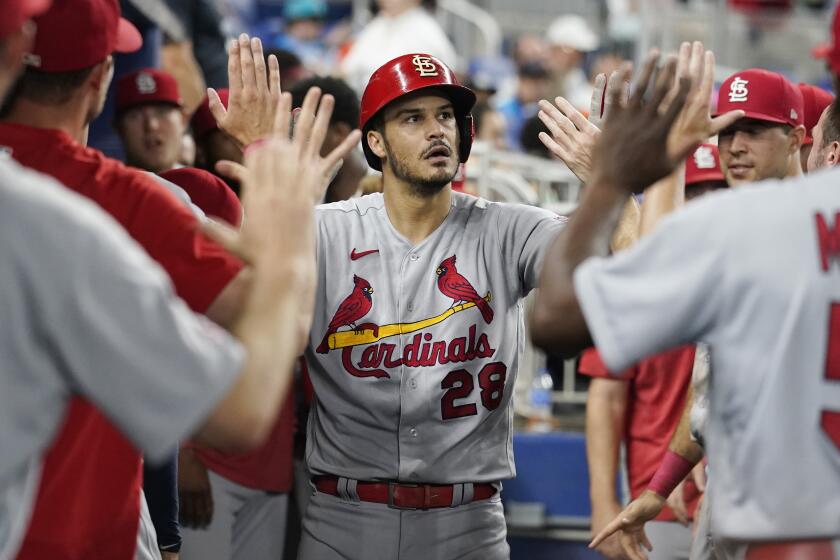 Cardinals third baseman Nolan Arenado is congratulated by his teammates after hitting a solo homer 