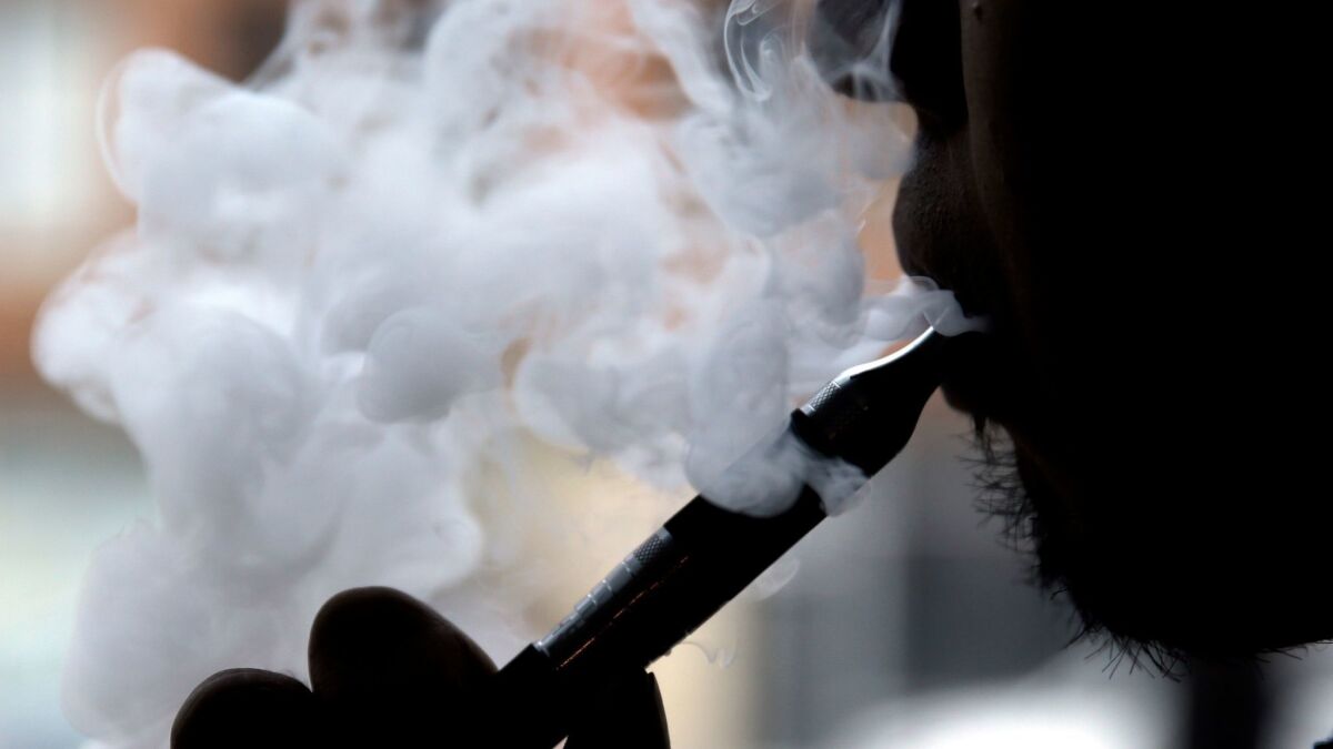 A man smokes an electronic cigarette in Chicago on April 23, 2014.
