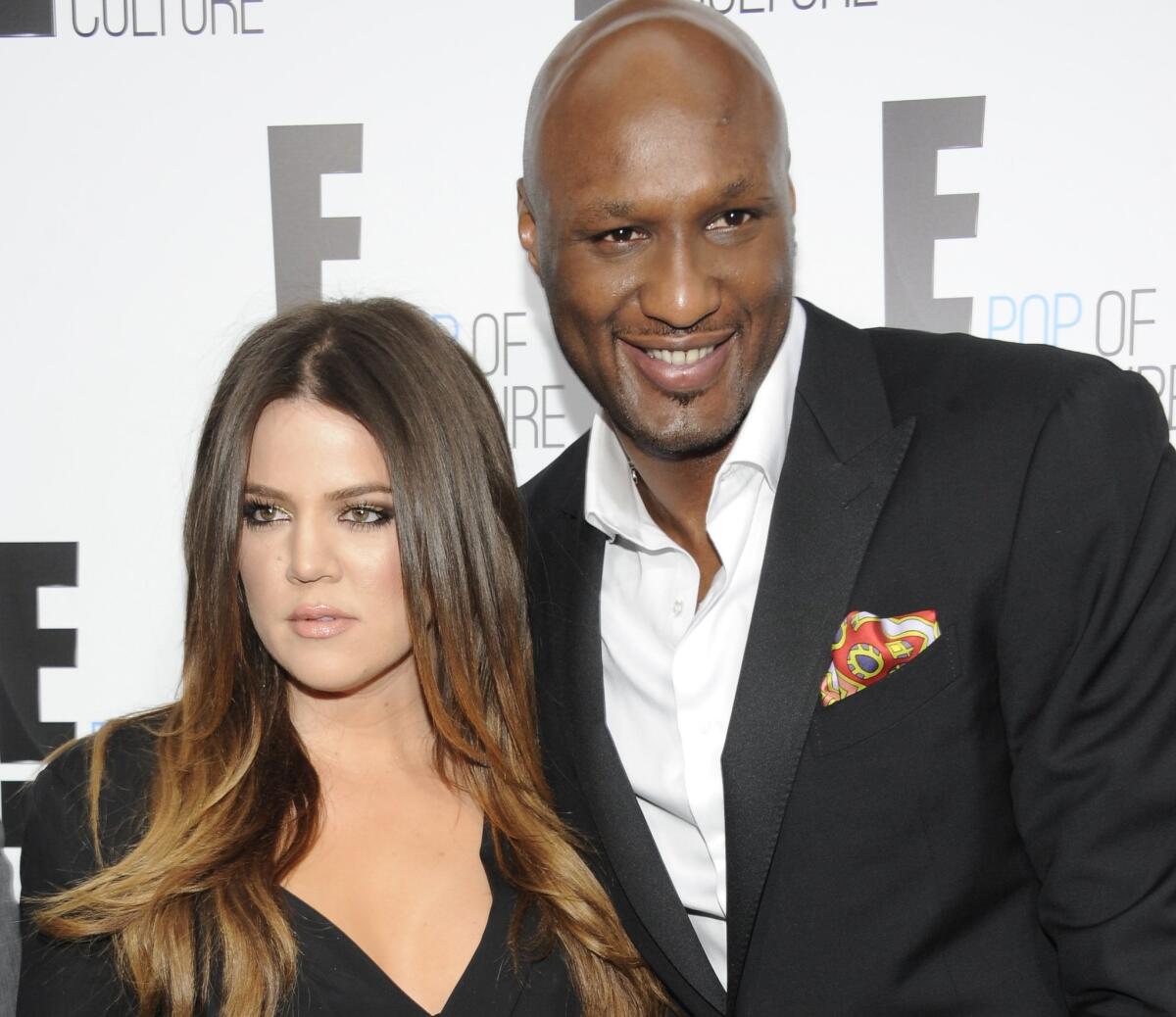 Khloe Kardashian had a strongly worded response on Twitter to those who say she's cashing in on estranged husband Lamar Odom's health scare. The couple is seen here at a 2012 event.