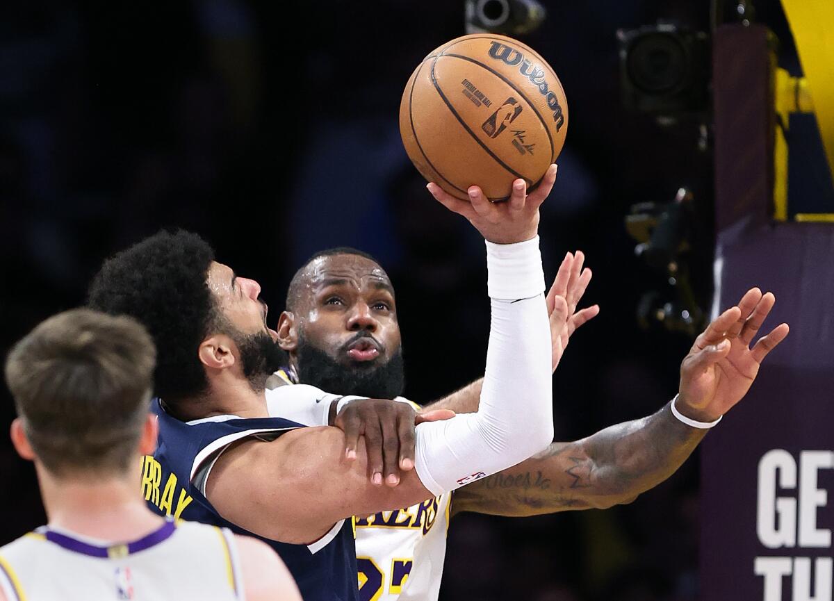 LeBron James prevents Jamal Murray from making a shot in the first half in Game 4.