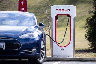 A Tesla Model S sedan is plugged into a Tesla Supercharger electrical vehicle charging station in Falls Church, Virginia, February 13, 2023. (Photo by SAUL LOEB / AFP) (Photo by SAUL LOEB/AFP via Getty Images)
