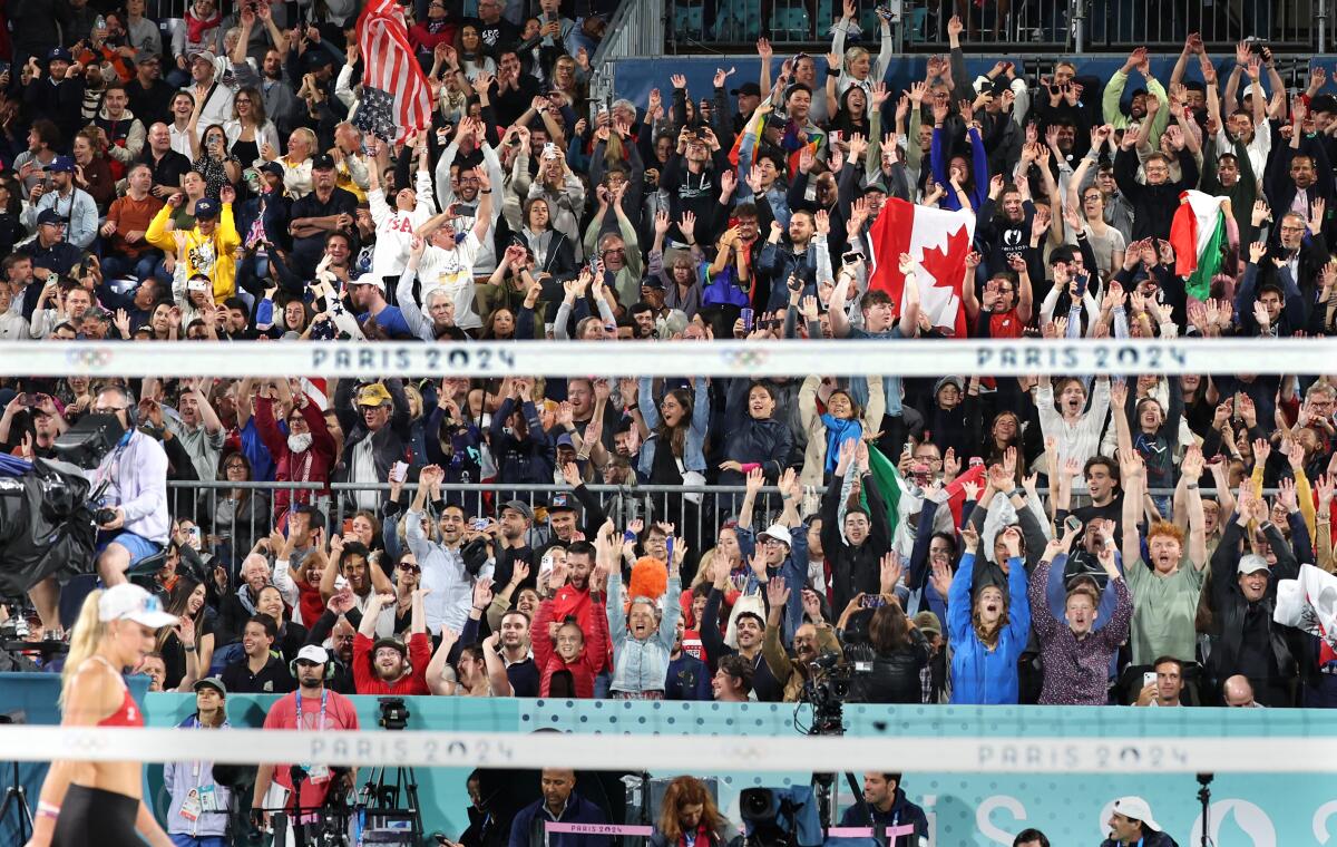 Fans do the wave during a beach volleyball match at the 2024 Paris Olympics.