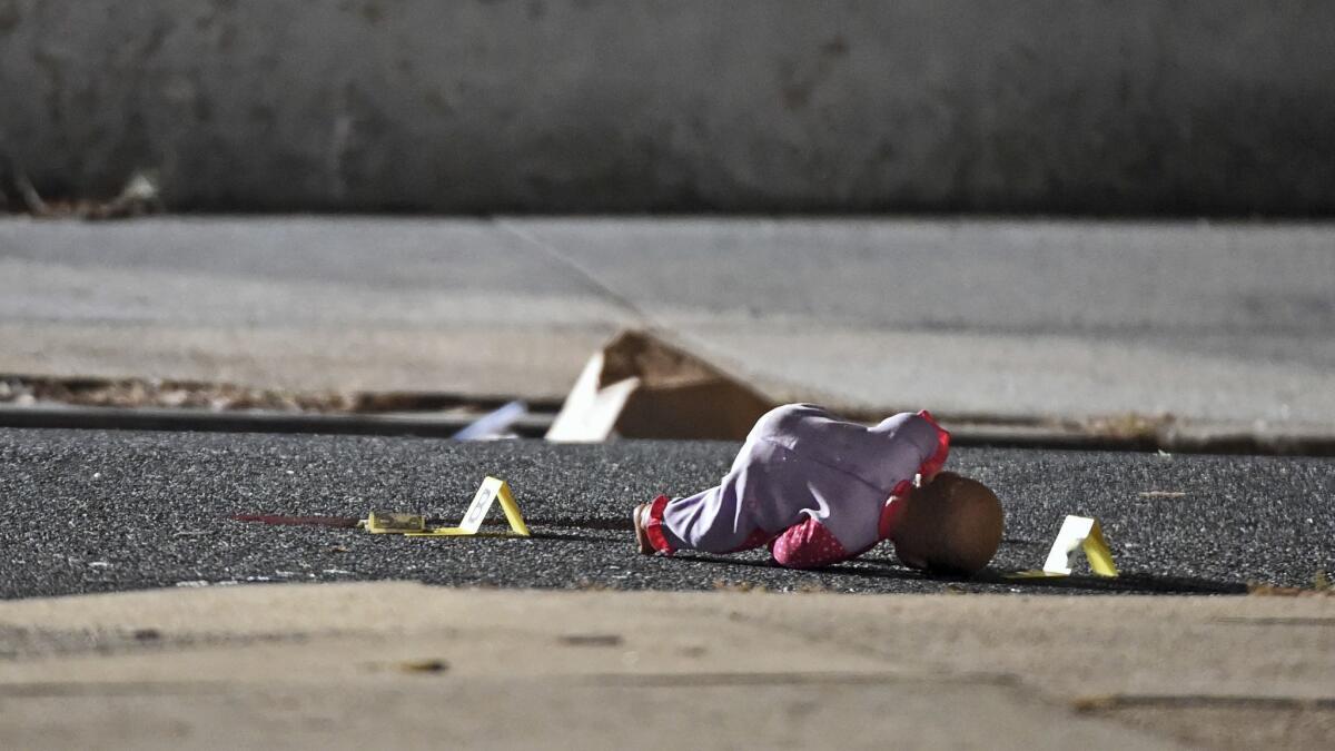 A doll lies next to evidence tags as police investigate the shooting of a 5-year-old girl in Baltimore.