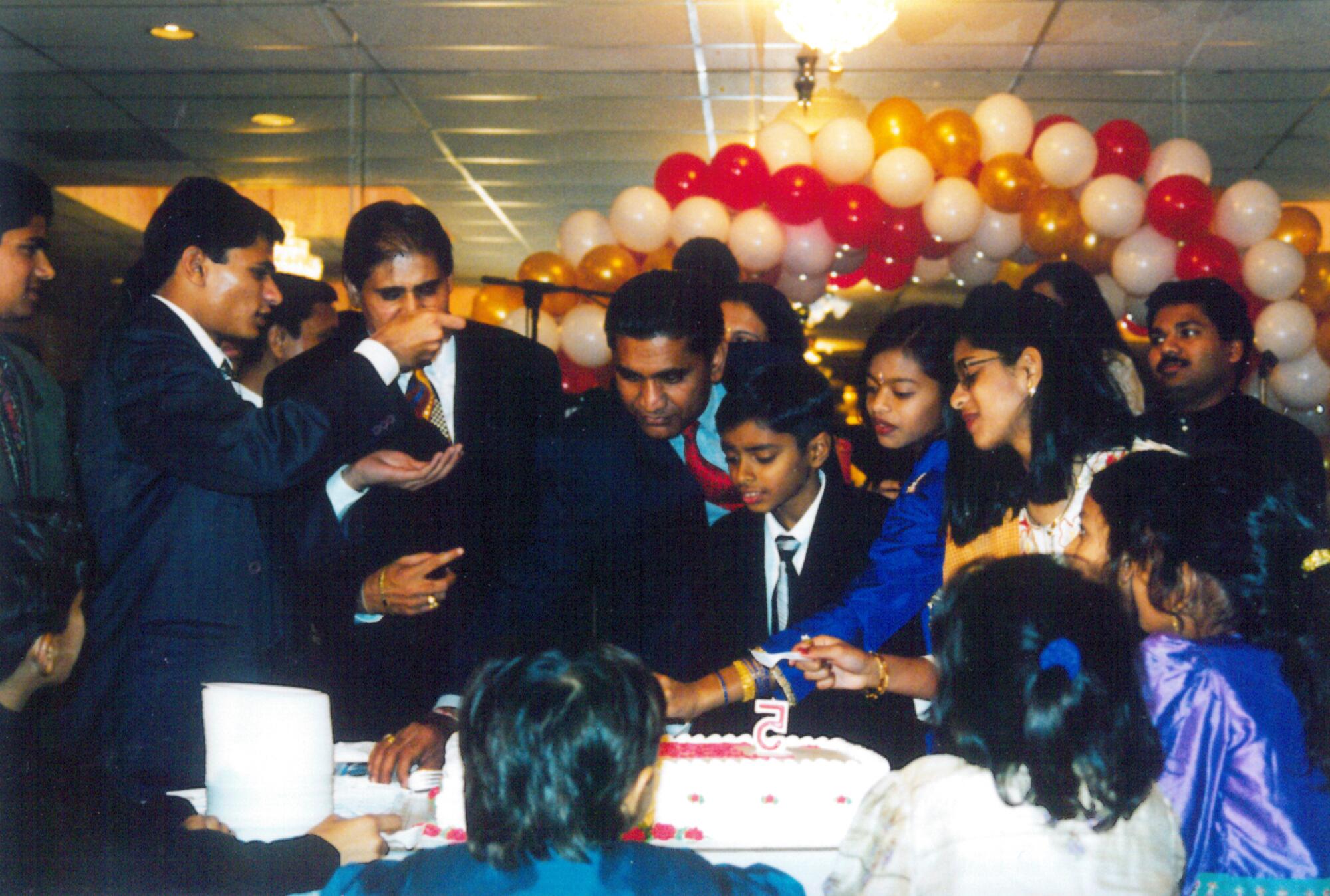 Haresh Jogani, center, and Shashikant Jogani, left, join family members at a celebration.