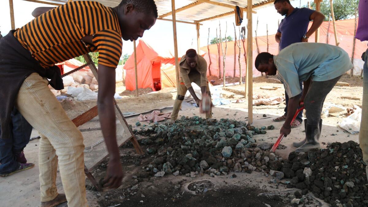 Artisanal miners sort cobalt and other minerals on the road between Kolwezi and Lubumbashi in the Democratic Republic of Congo.
