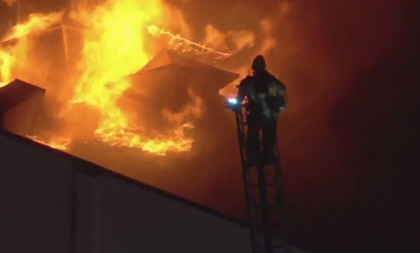 Firefighters battles a one-story blaze in downtown Los Angeles on Friday.