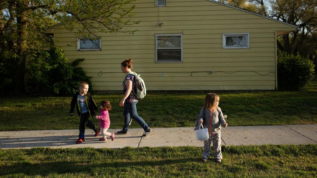 Clarisa Corber with children Lee, 6, Kaley, 1, and Abigail, 3, in Topeka, Kan. Like millions of Americans with job-based health coverage, Clarisa and her husband, Zack, are staggering under the weight of medical debt.