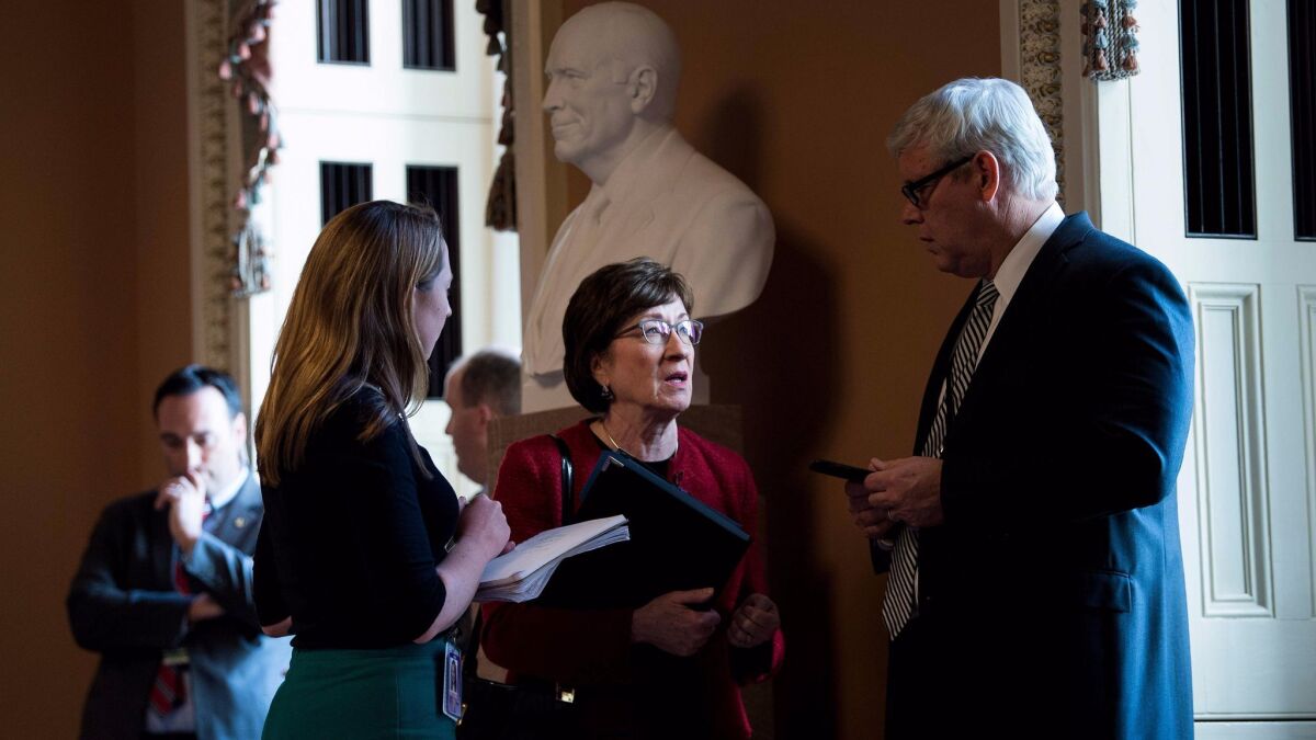 Sen. Susan Collins (R-Maine) speaks with staff before attending a meeting with other Republicans on Capitol Hill on Wednesday.