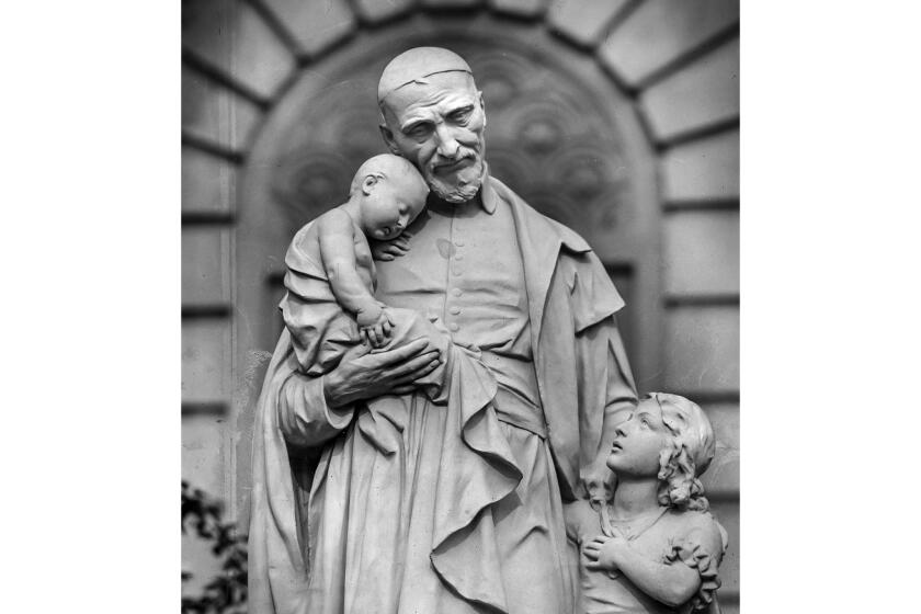 December 1955: Miniature statue of St. Vincent de Paul and the children that stands on the lawn in front of St. Vincent's Hospital on W 3rd St., at Alvarado St. This photo appeared in the Dec. 26, 1955 Los Angeles Times as part of the Know Your City photography series.