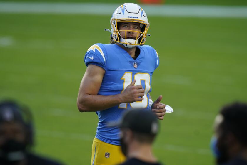 Los Angeles Chargers quarterback Justin Herbert (10) runs to the sidelines during the first half of an NFL football game against the Miami Dolphins, Sunday, Nov. 15, 2020, in Miami Gardens, Fla. (AP Photo/Lynne Sladky)