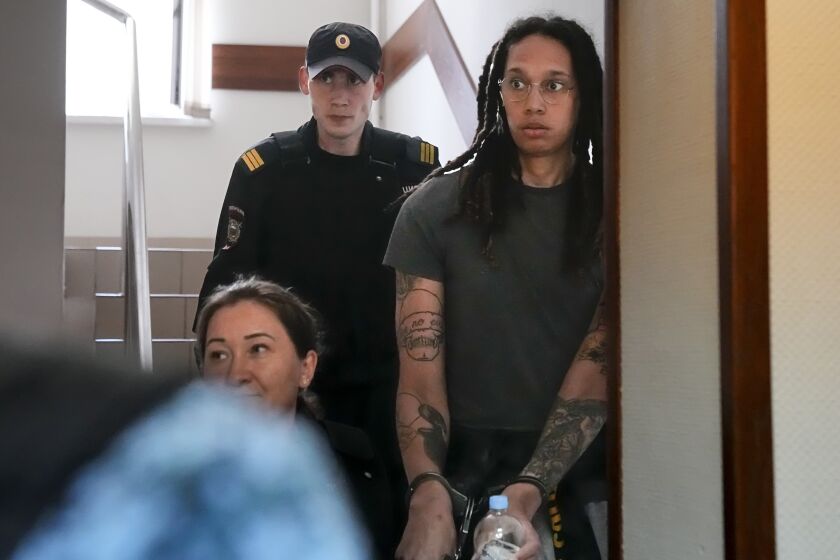WNBA star and two-time Olympic gold medalist Brittney Griner is escorted to a Russian courtroom for a hearing