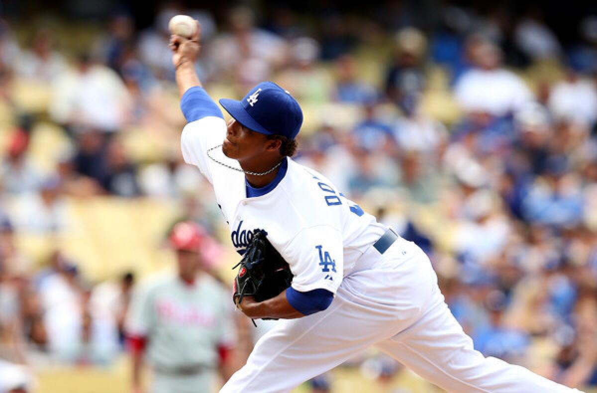 Dodgers reliever Jose Dominguez pitched a 1-2-3 eighth inning against the Phillies in his major league debut on Sunday at Dodger Stadium.