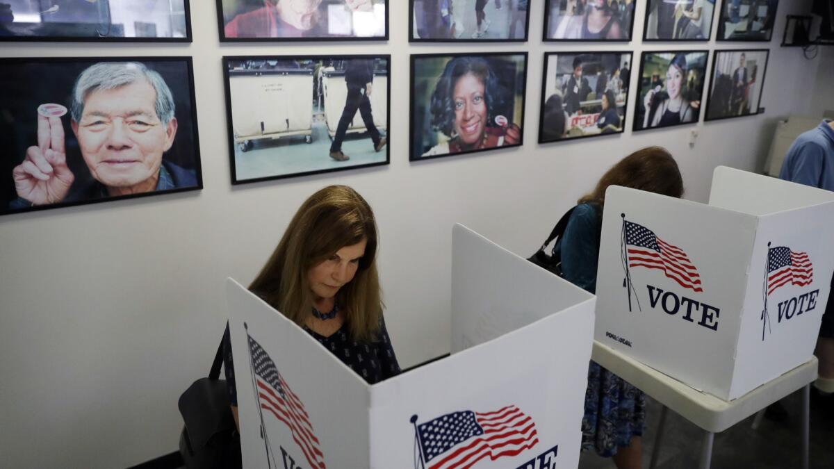Voters fill out their early ballots at the Los Angeles County Registrar of Voters office in Norwalk, Calif. on Oct. 23.