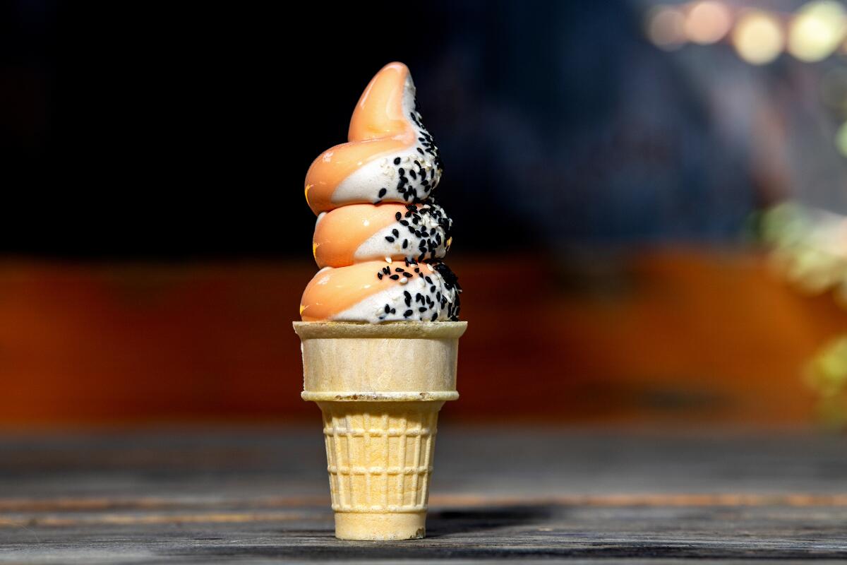 Hibiscus mango and black sesame vanilla swirl on a cone from Wax Paper.