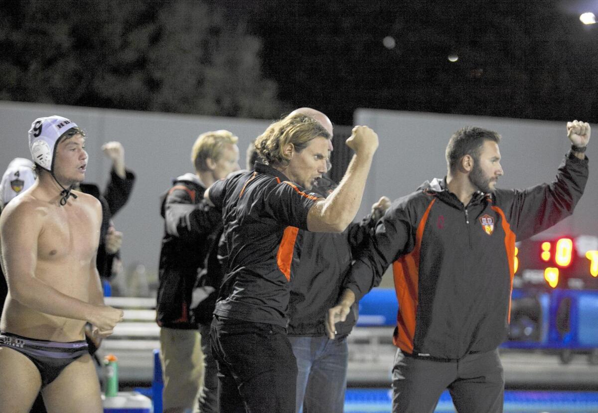Huntington Beach boys’ water polo Coach Sasa Branisavljevic celebrates a 7-6 win over Harvard-Westlake in the CIF Southern Section Division 1 semifinals at Woollett Aquatic Center on Wednesday.