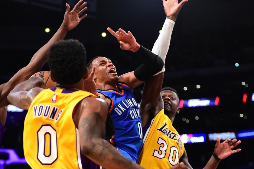 Thunder point guard Russell Westbrook (0) loses the ball between Lakers defenders Nick Young (0) and Julius Randle (30) during the first half on Tuesday.