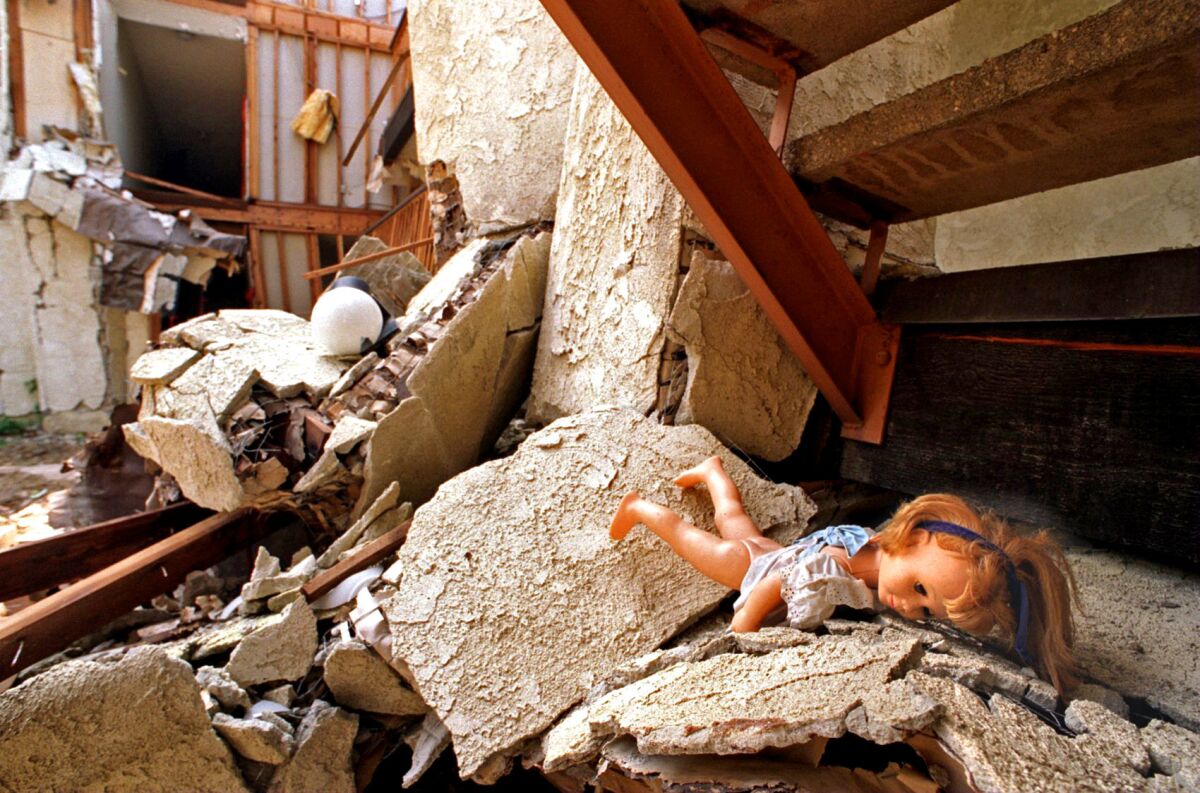 A doll lies amid the rubble in an area of Northridge Meadows where several bodies were found after the quake.