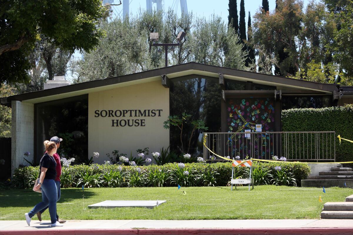 People walk past the Soroptimist House at Cal State Long Beach. The building, which had fallen into disrepair, was further damaged by last week’s magnitude 7.1 earthquake.