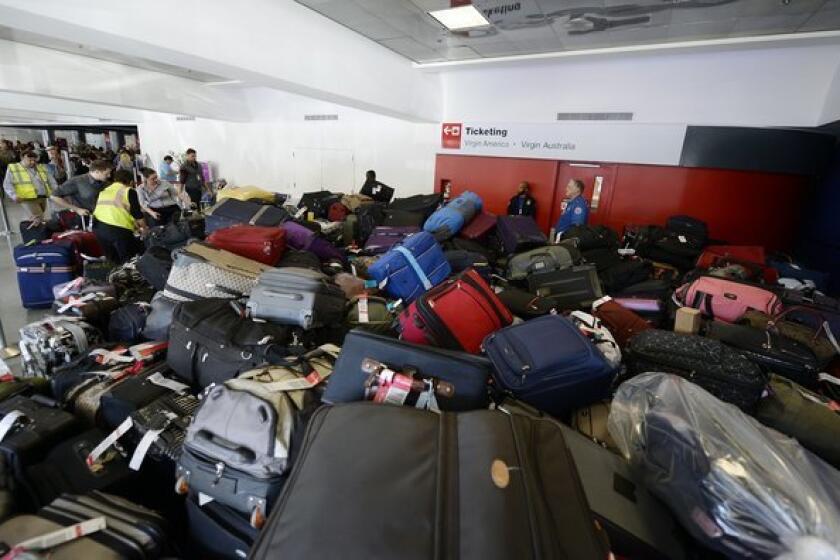 Luggage waits to be screened in Terminal 3 a day after the LAX shooting.