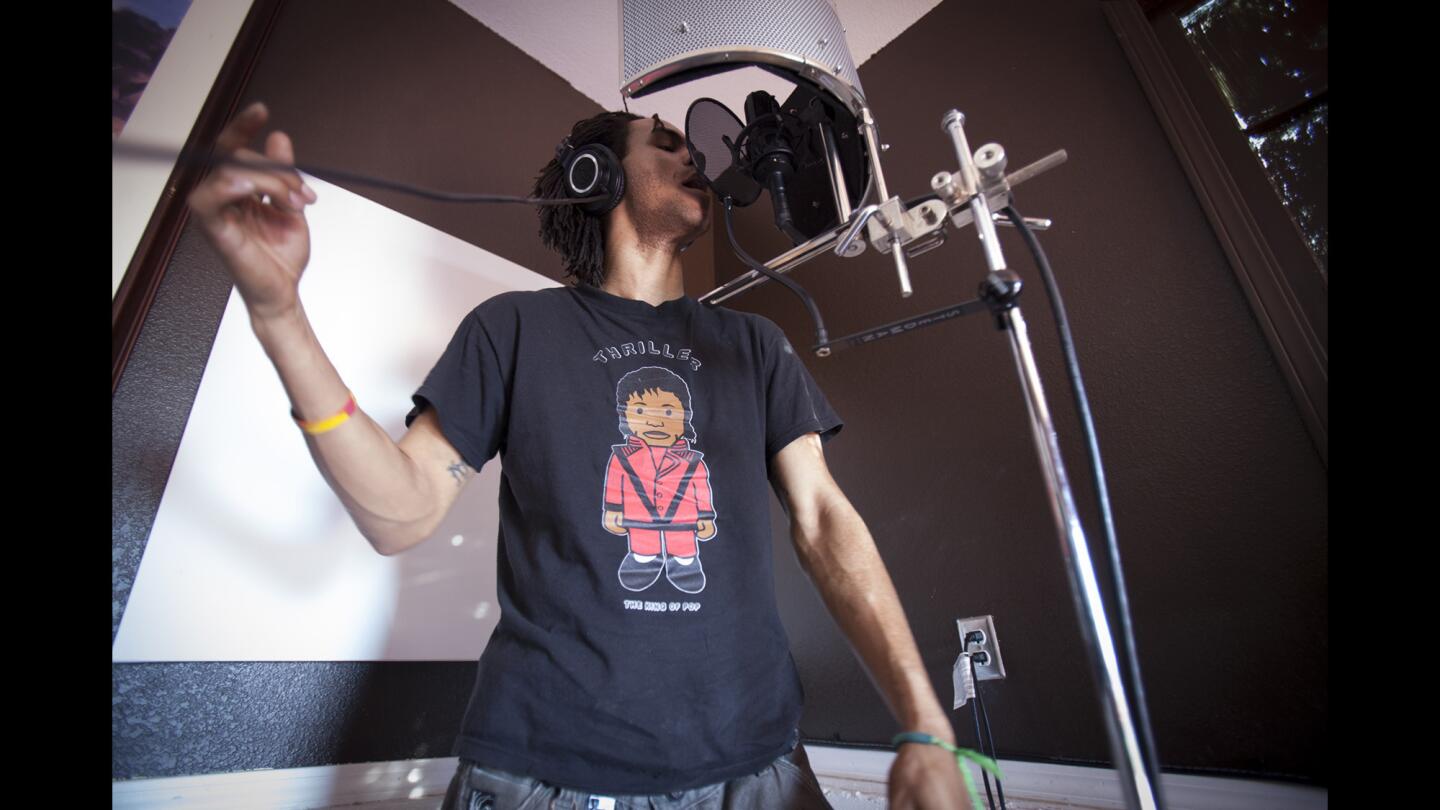 Roberto "Visualeyes" McCoy, an Oakland rapper, records tracks for "Afro Samurai 2" at David Robinson's home studio. Robinson, the game's developer, had liked a CD that McCoy, a Safeway checker, had given him while waiting in line.