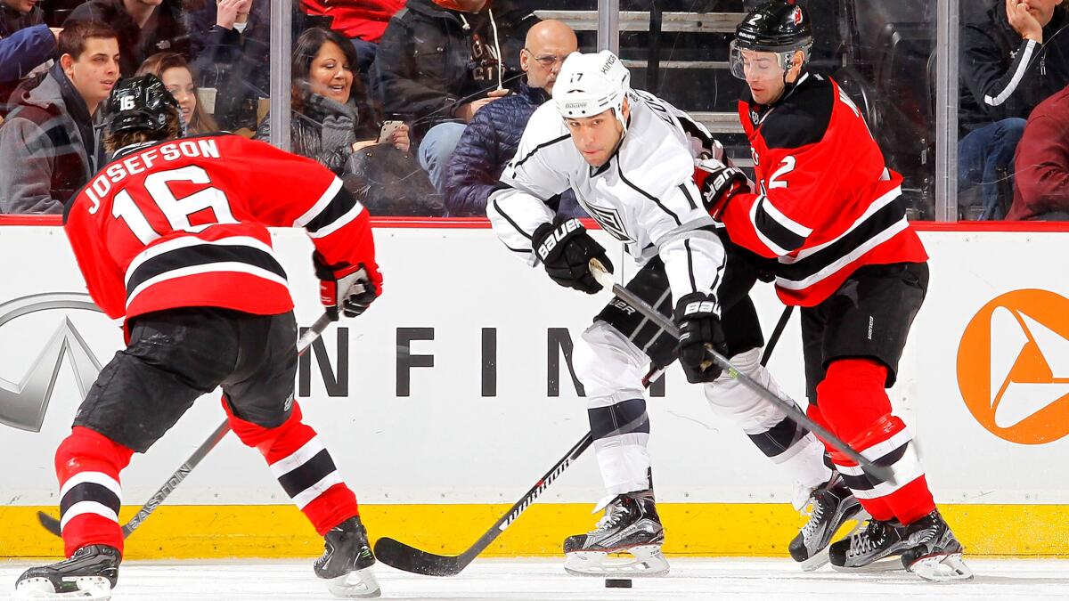 Left wing Milan Lucic, trying to pass the puck up ice against New Jersey's John Moore (2) and Jacob Josefson on Feb. 14, is one of several veteran the Kings have brought in to help rebuild a contender.