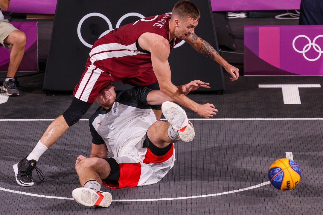 Latvia's Karlis Lasmanis leaps over ROC's Ilia Karpenov