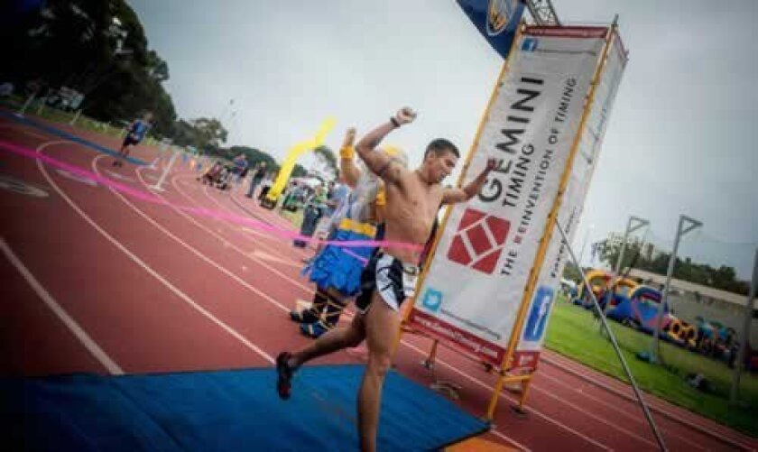 Nick Sigmon completes the 3.1-mile route across UC San Diego and burst through the finish line in just over 15 minutes. Erik Jepsen/UC San Diego Publications
