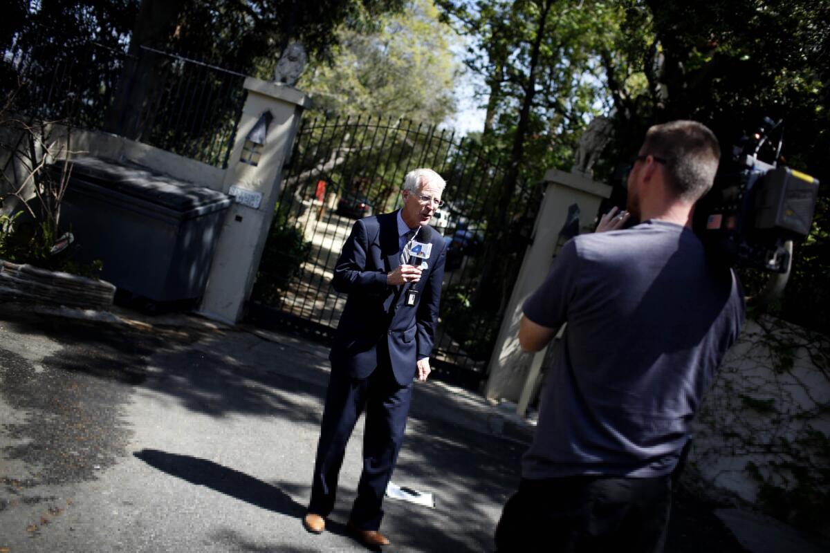 News media stand in front of Andrew Getty's Hollywood Hills mansion, where the heir to the Getty oil fortune was found dead Tuesday.