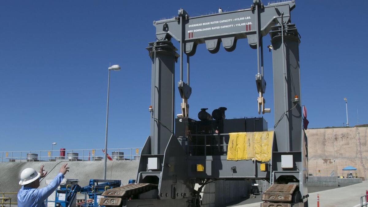Jim Peattie, general manager for decomissioning oversight, explains how this specialized crane is used to lower the vessels holding spent nuclear fuel into the holding facility.