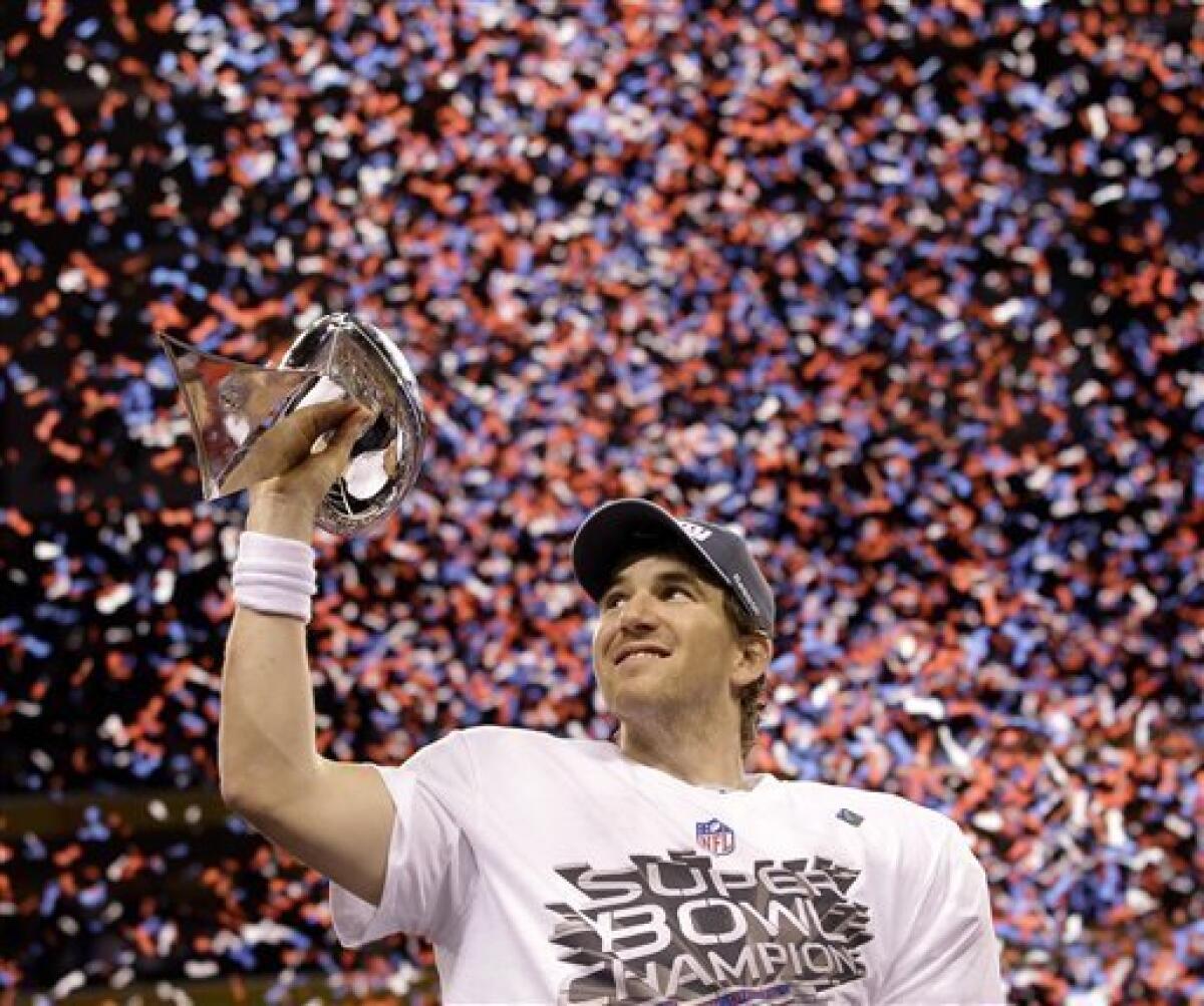 New York Giants and MVP quarterback Eli Manning celebrates after defeating  the New England Patriots at Super Bowl XLVI at Lucas Oil Stadium on  February 5, 2012 in Indianapolis. New York beat