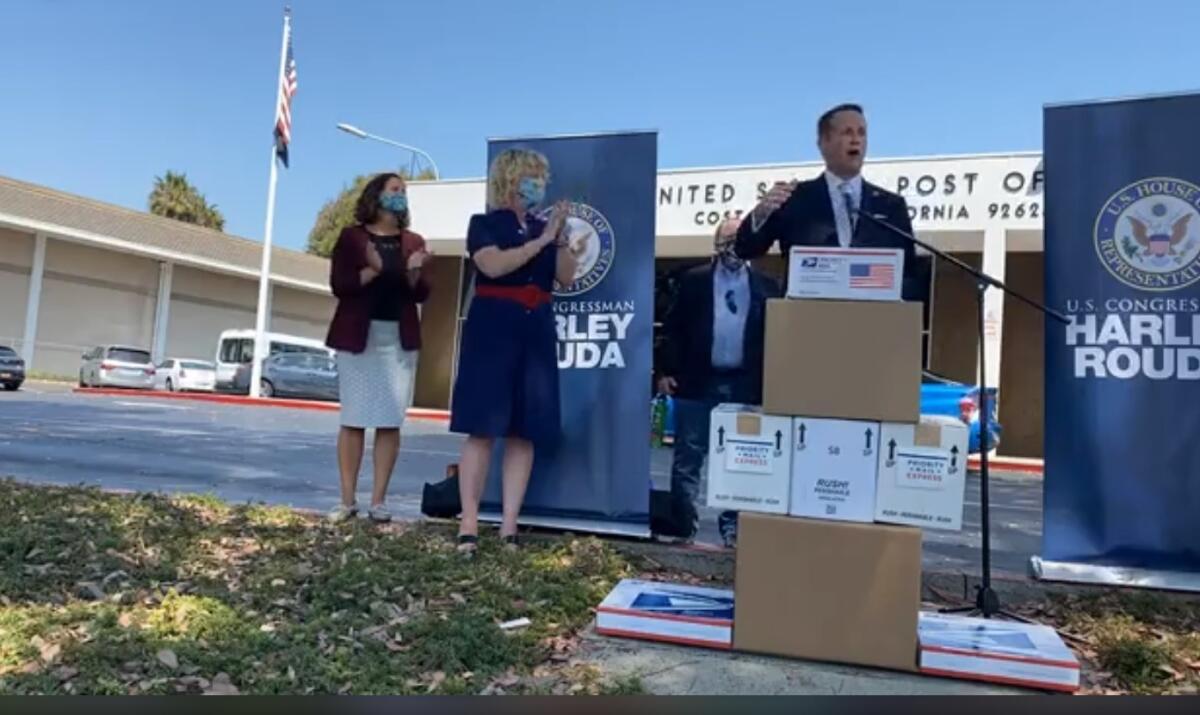 Rep. Harley Rouda speaks at the Costa Mesa post office on Adams Avenue Tuesday.