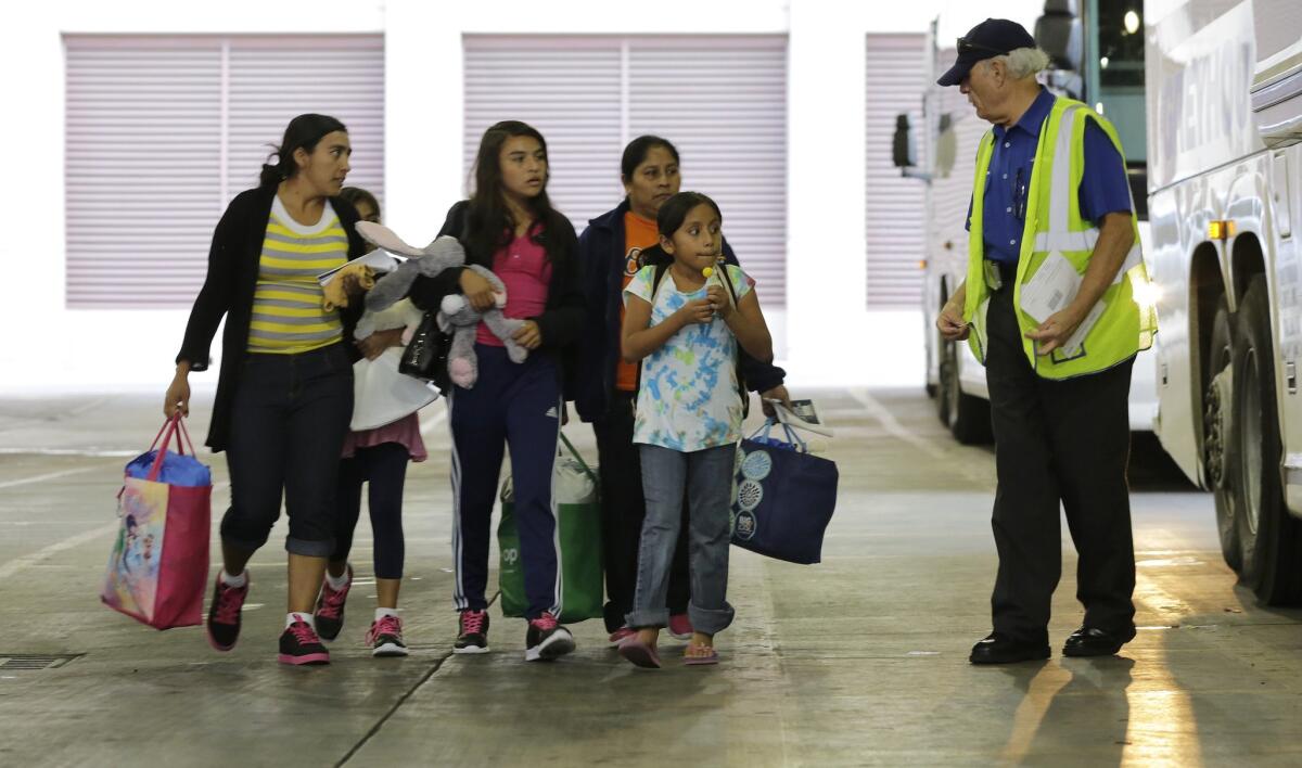 Immigrants from El Salvador and Guatemala who entered the country illegally prepare to board a bus in San Antonio after they were released from a family detention center in Texas.