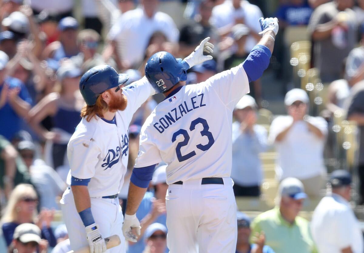 Dodgers first baseman Adrian Gonzalez celebrates his eighth-inning, two-run homer with on-deck hitter Justin Tuner. The Dodgers won 4-3.