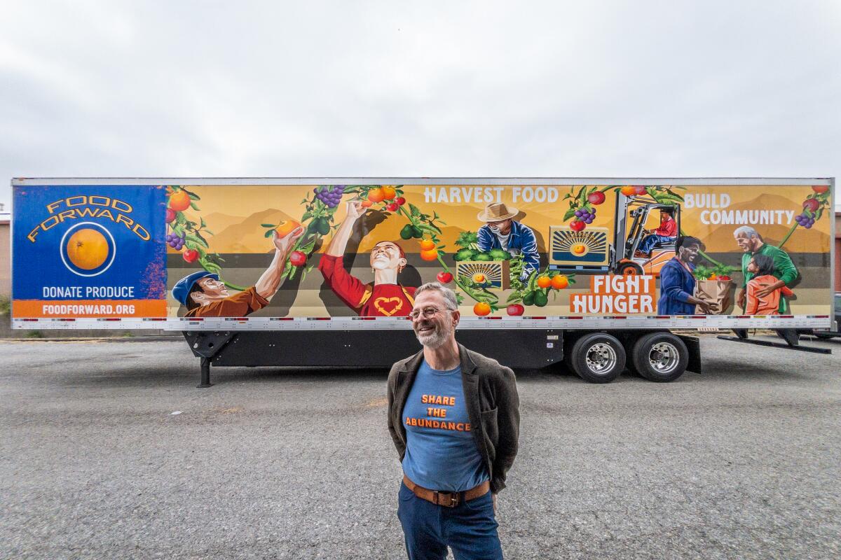 Rick Nahmias in front of a new Food Forward trailer with colorful decorations and slogans like "Fight Hunger."