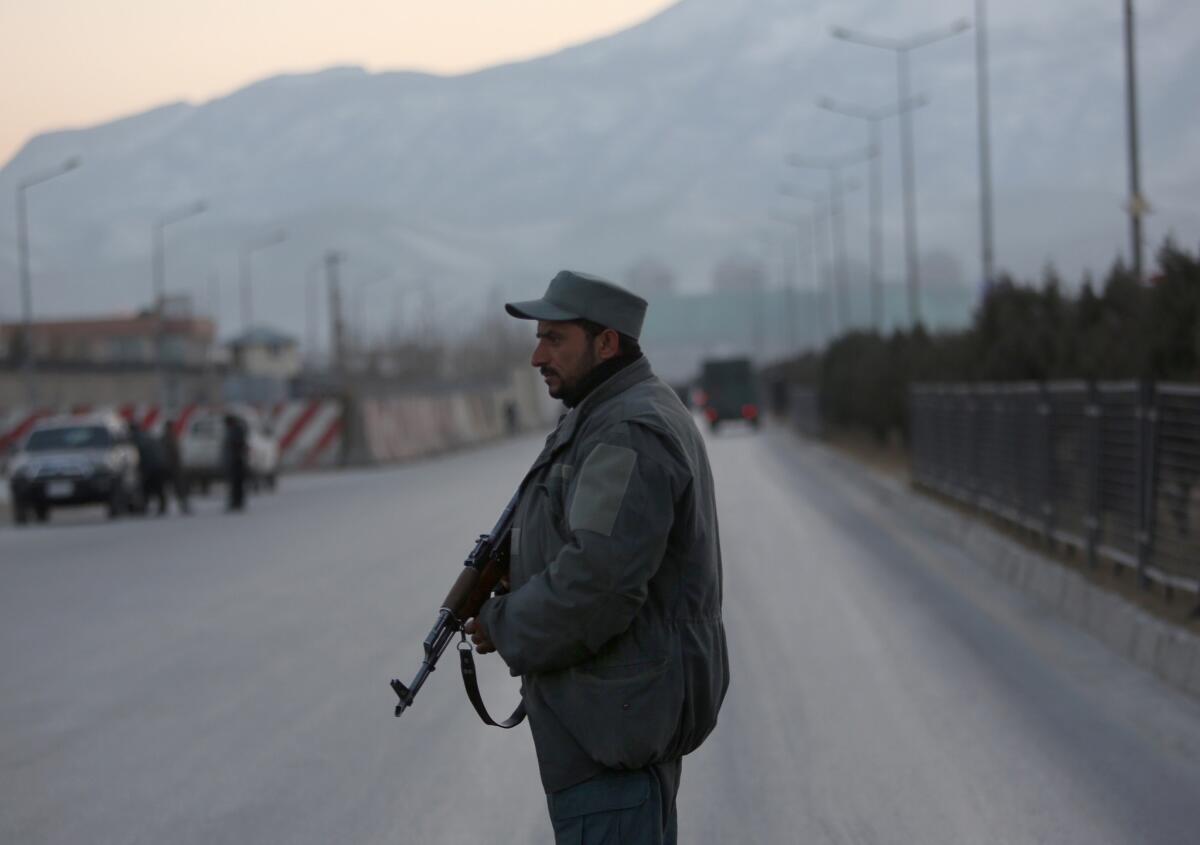 A member of the Afghan security forces stands guard near the site of two blasts in Kabul on Jan. 10, 2017.