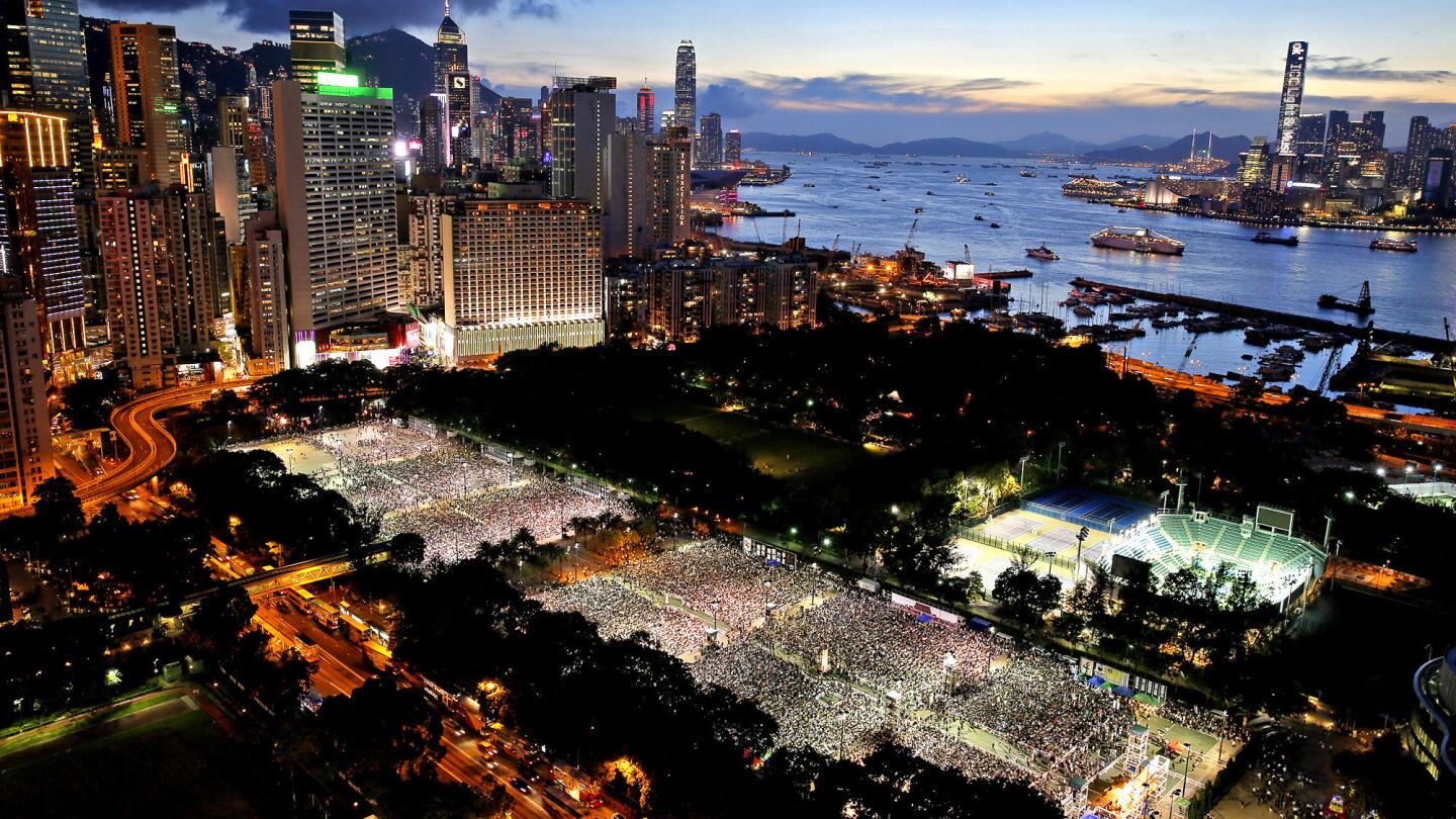 Tens of thousands of people attend a candlelight vigil at Victoria Park in Hong Kong to mark the 25th anniversary of the Chinese military crackdown on pro-democracy demonstrators in Beijing.