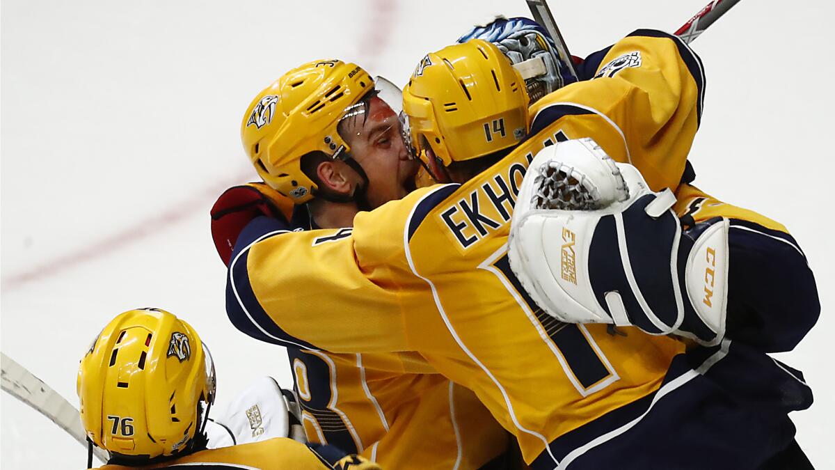 Predators teammates Viktor Arvidsson, left, and Mattias Ekholm embrace at the conclusion of a 6-3 win over the Ducks.