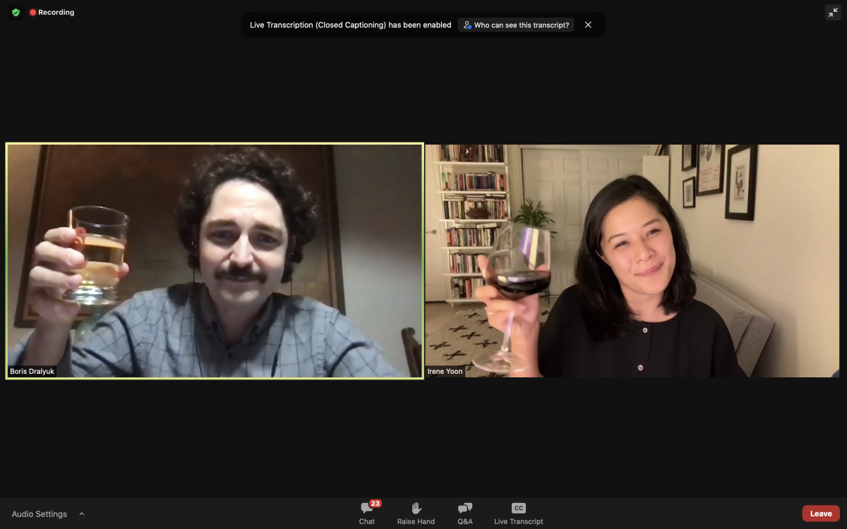  Two people on Zoom raise their glasses 