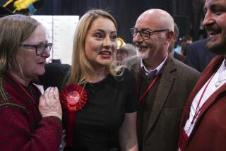 Labour Party candidate Gen Kitchen celebrates with her family after being declared winner in the Wellingborough by-election at the Kettering Leisure Village, Northamptonshire, Friday Feb. 16, 2024. (Joe Giddens/PA via AP)