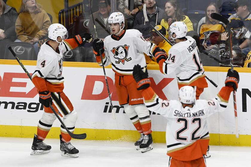 Anaheim Ducks right wing Troy Terry (19) celebrates with teammates after tying the score during the third period of an NHL hockey game against the Nashville Predators on Tuesday, Nov. 29, 2022, in Nashville, Tenn. The Predators won in overtime, 2-1. (AP Photo/Mark Zaleski)