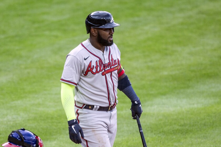 Atlanta Braves' Marcell Ozuna (20) stands with his bat during the seventh inning of a baseball game against the Philadelphia Phillies, Saturday, April 3, 2021, in Philadelphia. The All-Star Game patch that appeared on the right sleeve of the Braves' jerseys during opening day was sewn over Saturday against Philadelphia at Citizens Bank Park. (AP Photo/Laurence Kesterson)