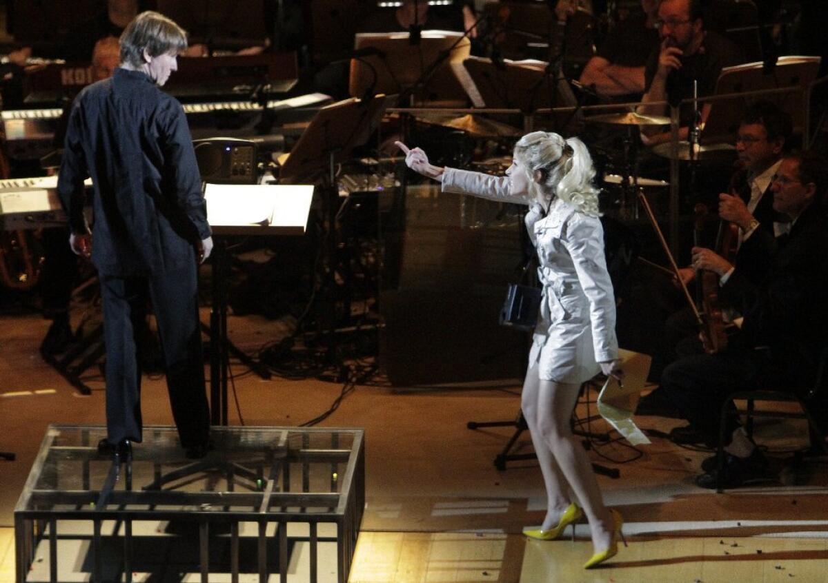 Hila Plitmann, playing the Soprano Solo, gestures toward conductor Esa-Pekka Salonen during the Los Angeles Philharmonic's 2013 concert of Frank Zappa's "200 Motels: The Suites." A recording of the performance will be released Nov. 20.