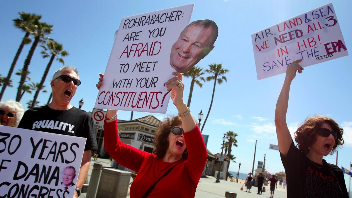 Constituents from California's 48th Congressional District protest in Huntington Beach in an effort to get Rep. Dana Rohrabacher to hold a town hall meeting. (Luis Sinco / Los Angeles Times)