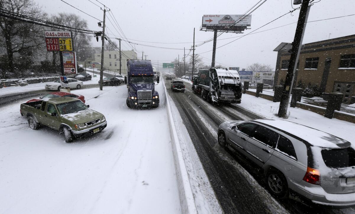 A two-vehicle accident blocks an icy highway in Jersey City, N.J., on Tuesday.
