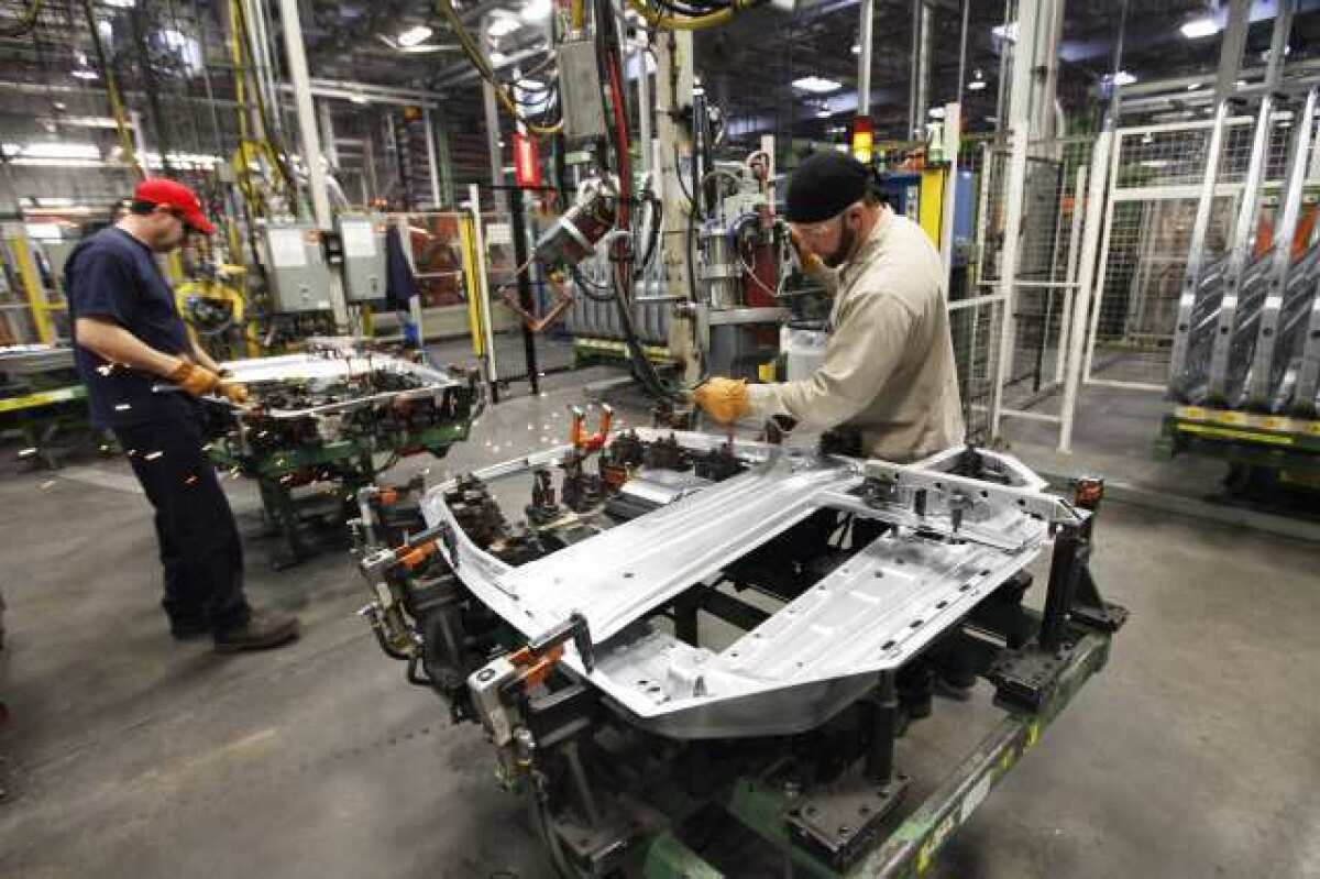 Americans get an average of 20 days of paid vacation and holidays, about half as much time off as Russians. Above, a Volvo truck assembly line in Dublin, Va.