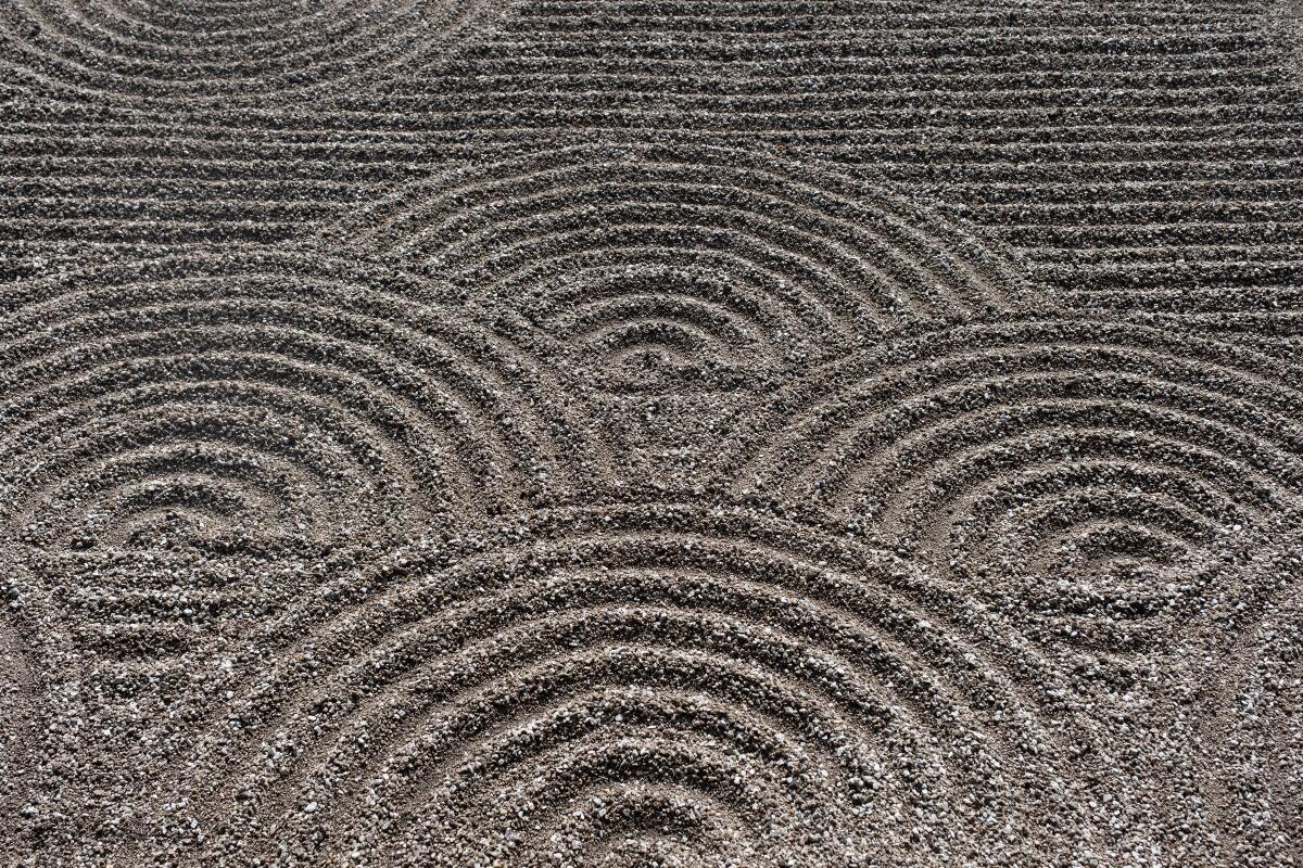 Monks rake ripple patterns in the gravel at Tofuku-ji as part of their Zen practice.